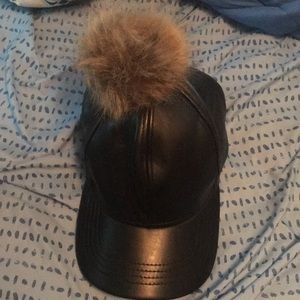 Leather hat with blonde bunny tail on top.